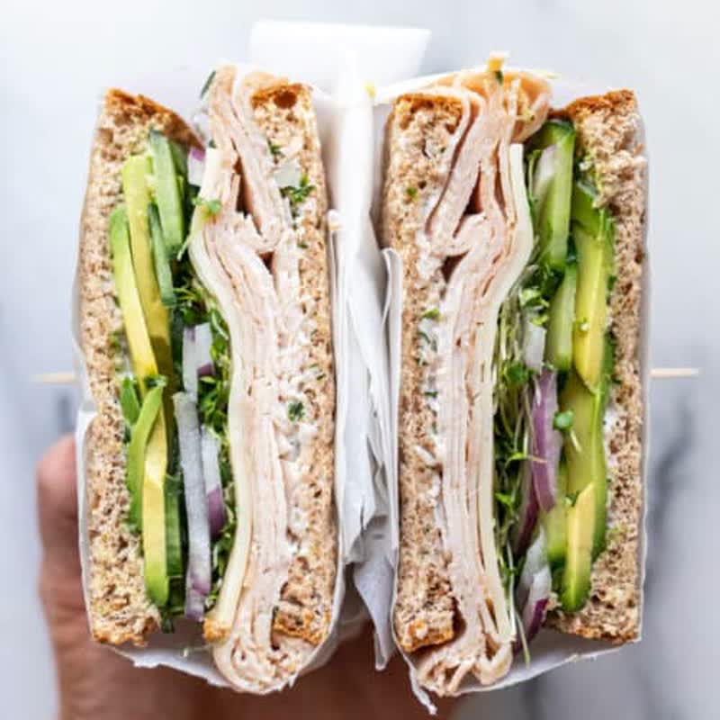 Turkey avocado sandwich with Swiss, lettuce, and tomato