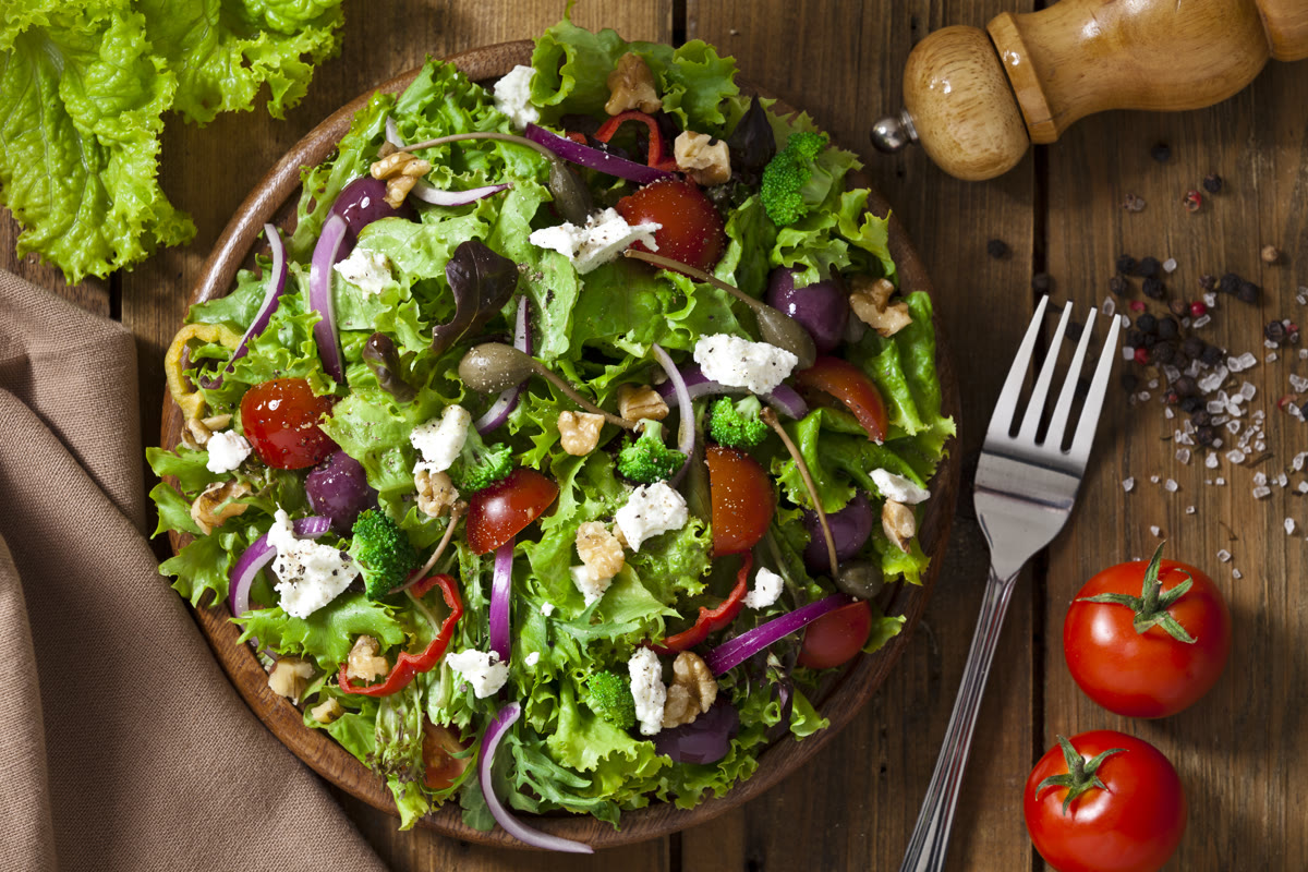 Fresh garden salad with tomatoes, feta, olives, and greens